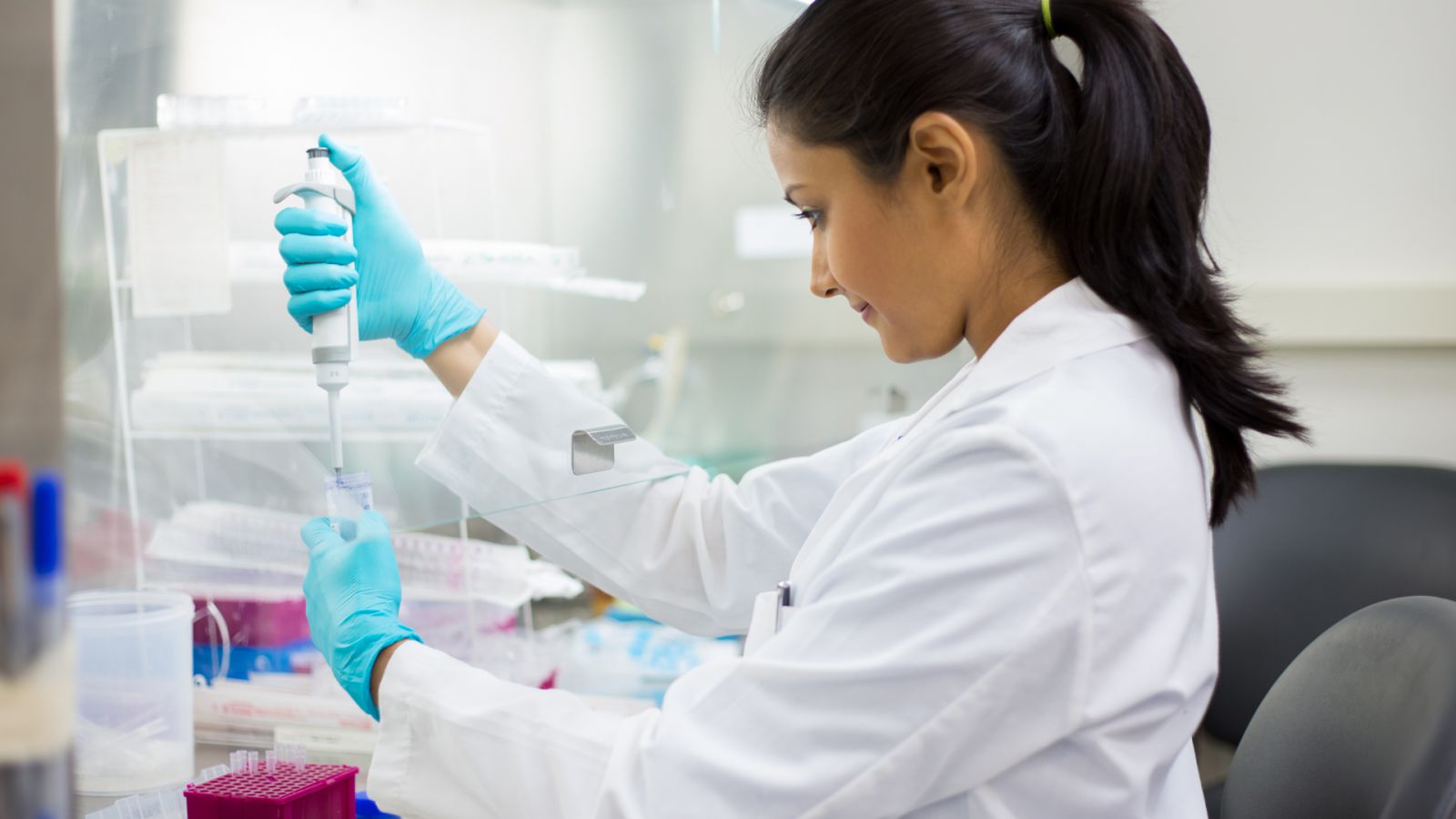 A medical or science professional analyzes samples in a lab